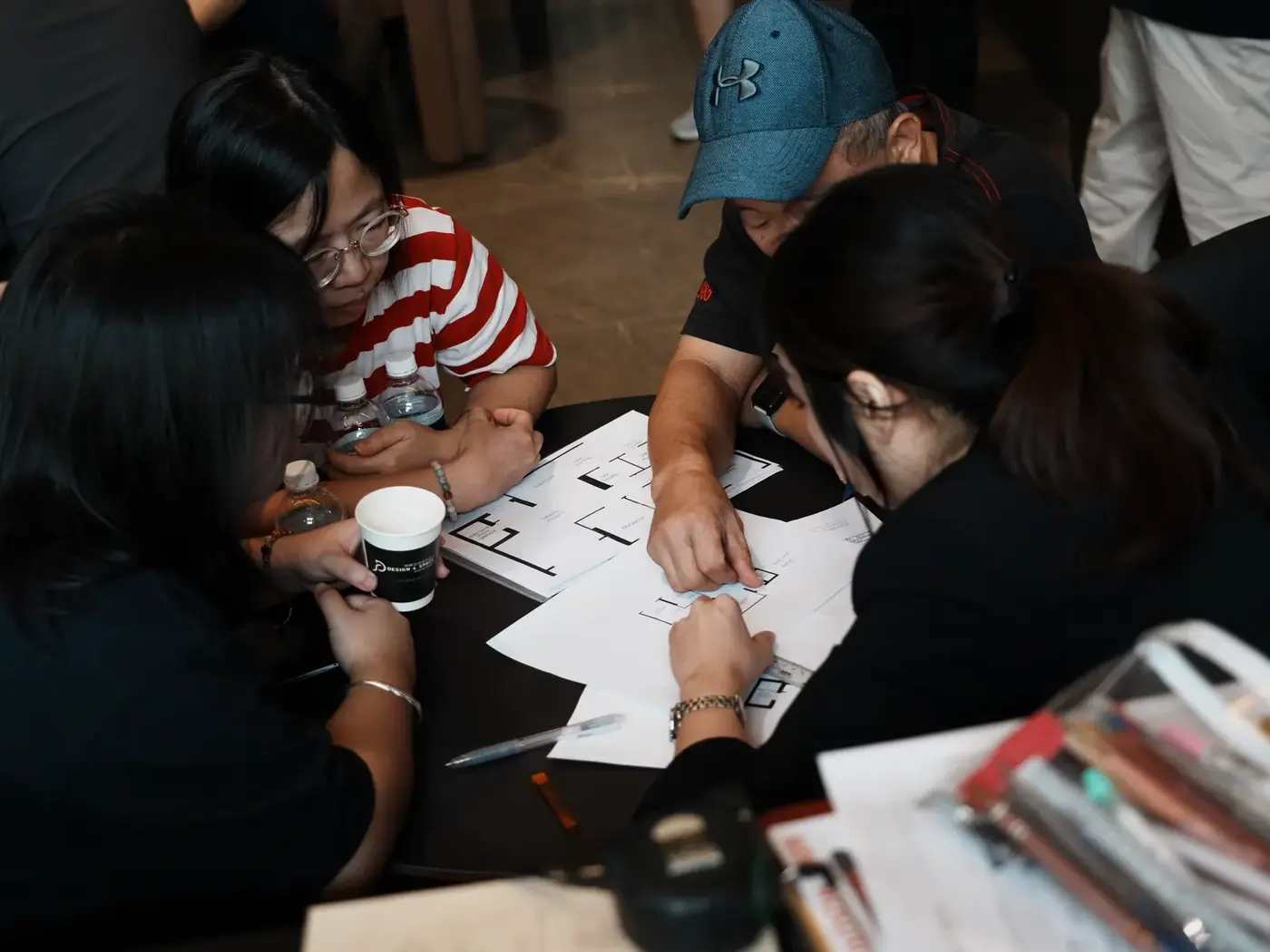 Floor plans and material samples spread across a table