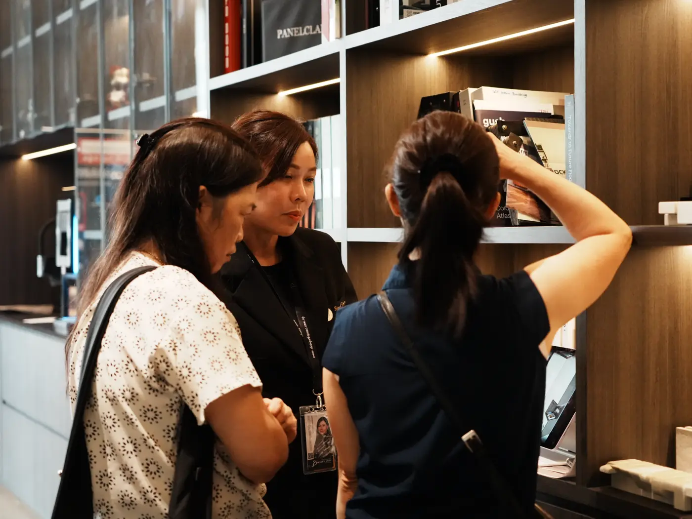 Homeowners inspecting a floor-to-ceiling feature wall display